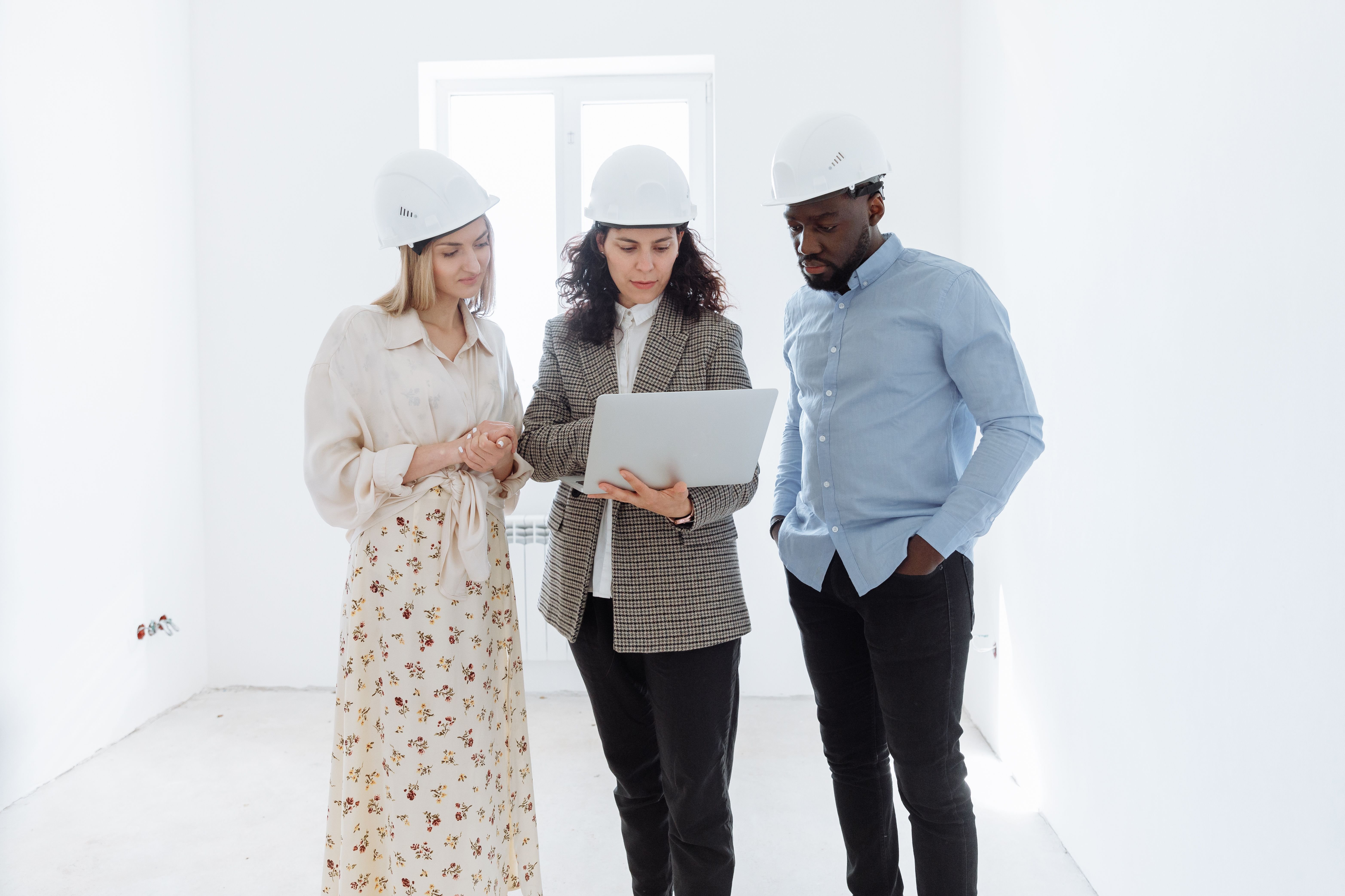 Construction manager reviewing a work-in-process schedule at a project site.