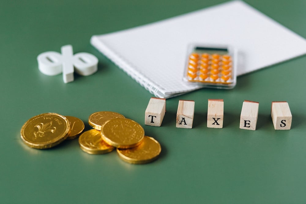 desktop with coins and the word taxes