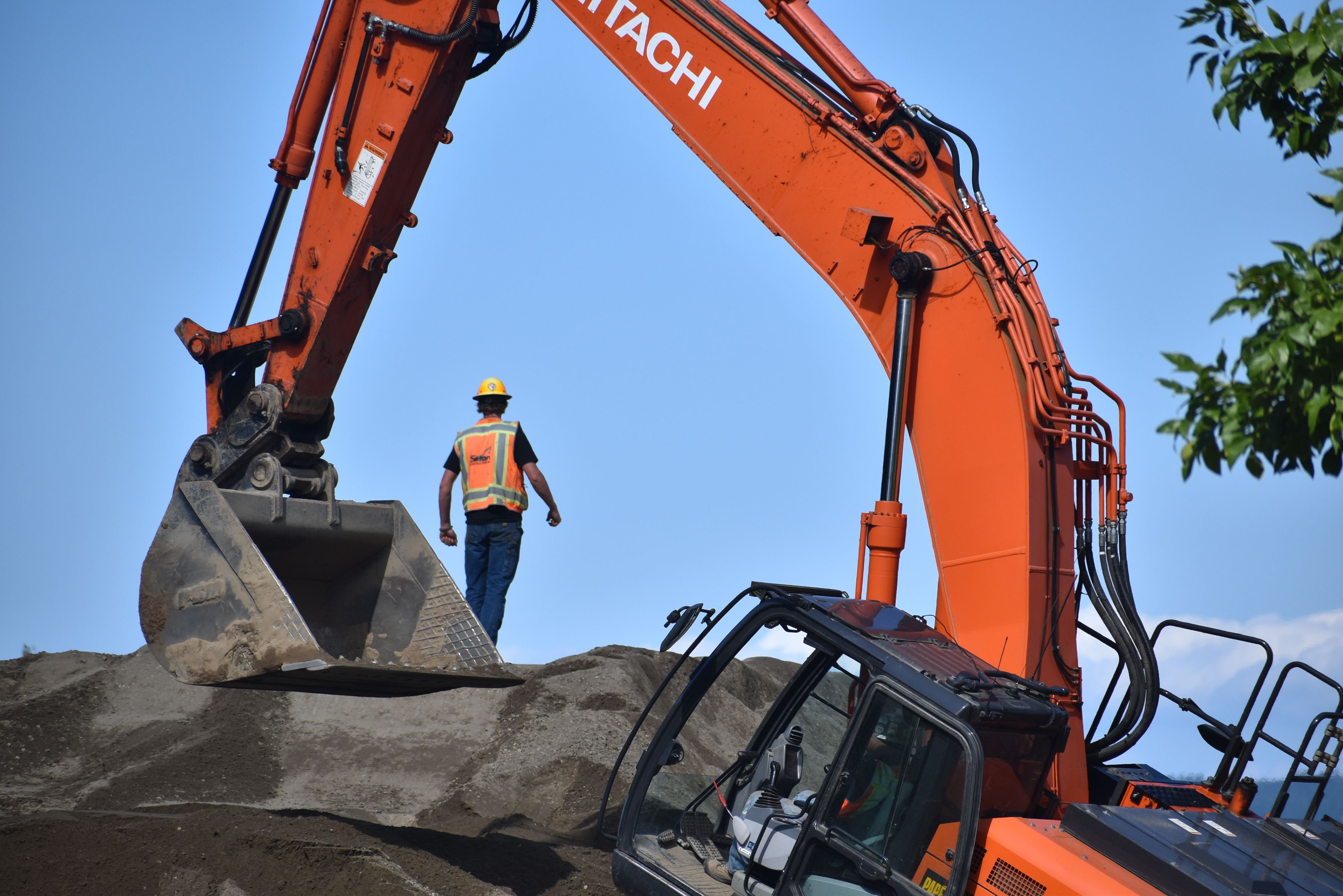 a project manager near an excavator