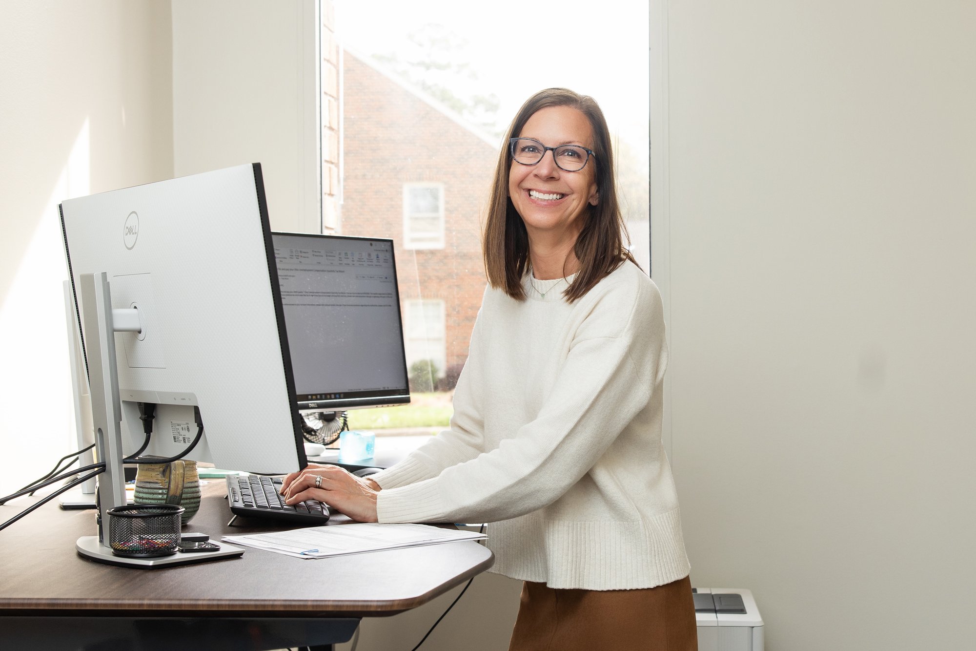 Professional portrait of a Stancil CPA team member standing at her workstation.