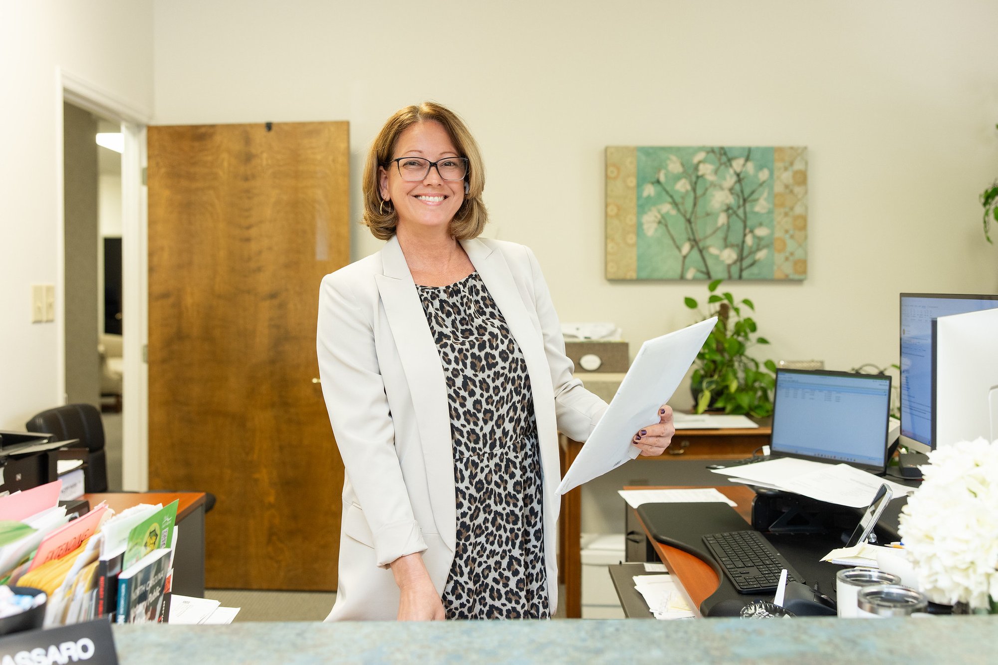 Stancil CPA team member standing in her office holding client documents.
