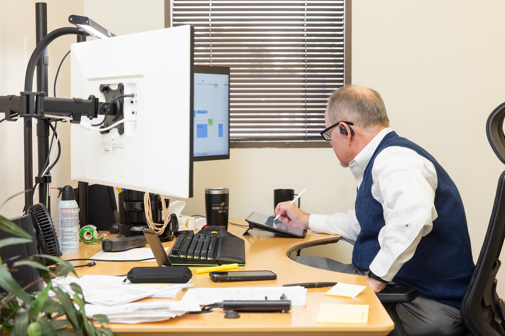 Team member reviewing documents and participating in an online meeting at Stancil CPA.